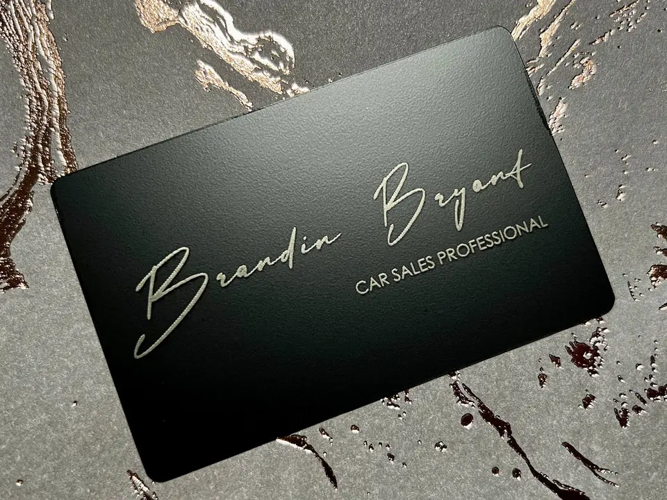A black anodized stainless steel NFC card with engraved personalization