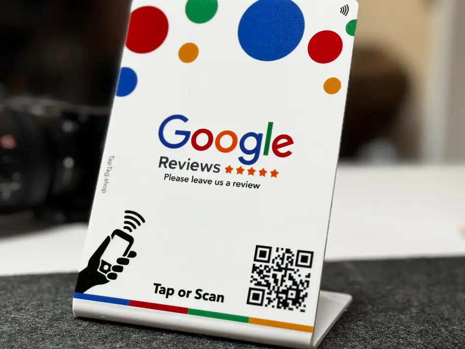 A freestanding tap-or-scan counter sign on a front desk